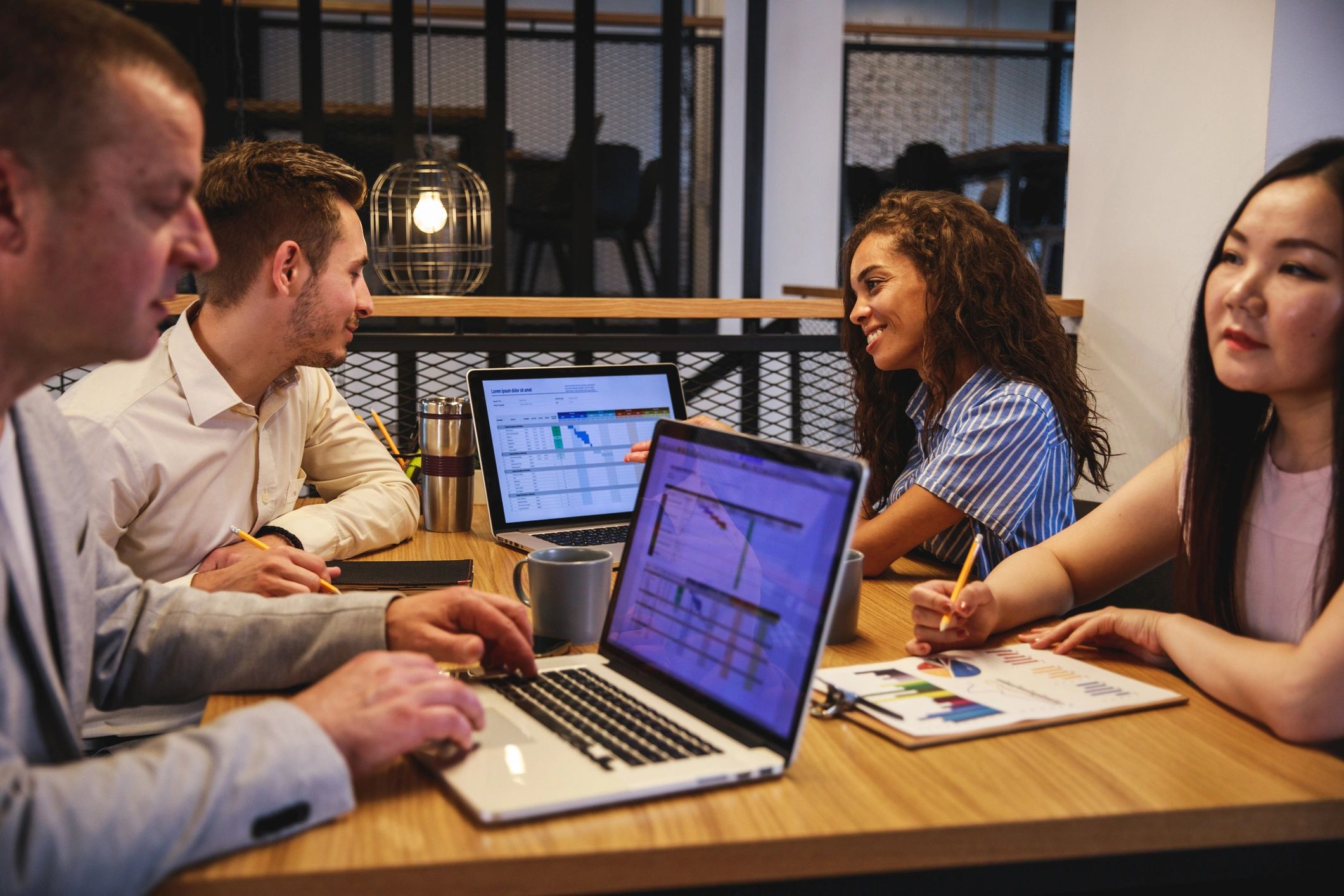 Business partners in a board room reviewing project details
