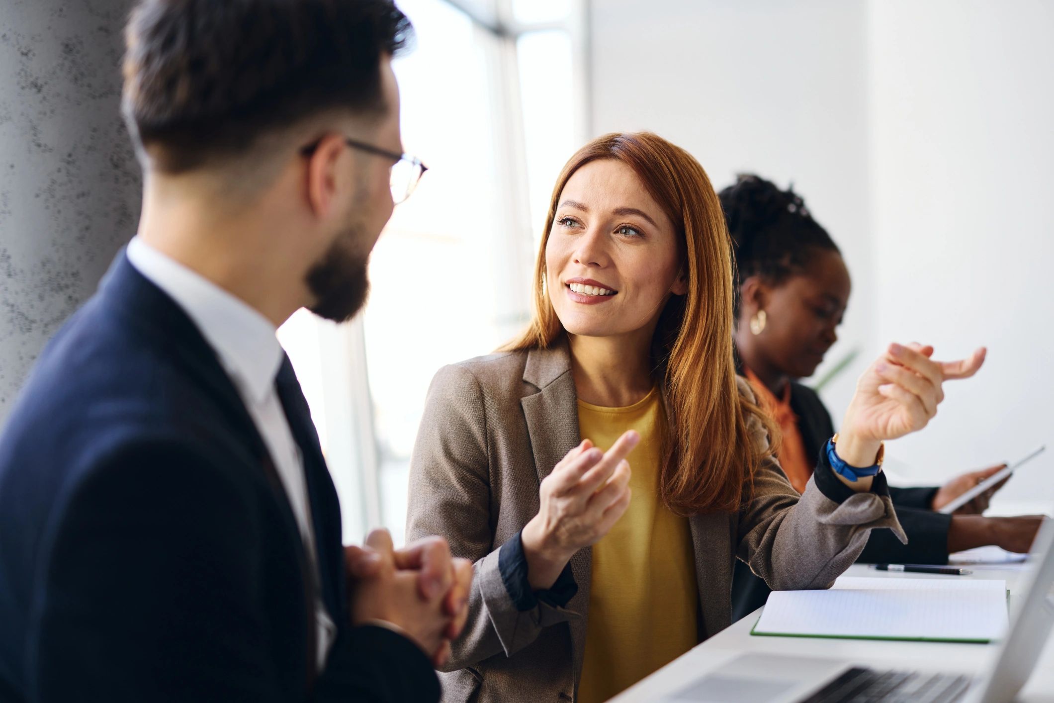Business professionals discussing a project in a modern office